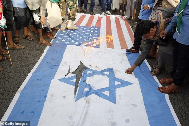 Flags were then set on fire by angry protesters