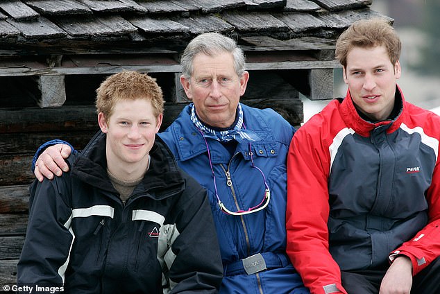 King Charles with his arms around Prince William and Prince Harry during the royal family's ski break in the region at Klosters on March 31, 2005