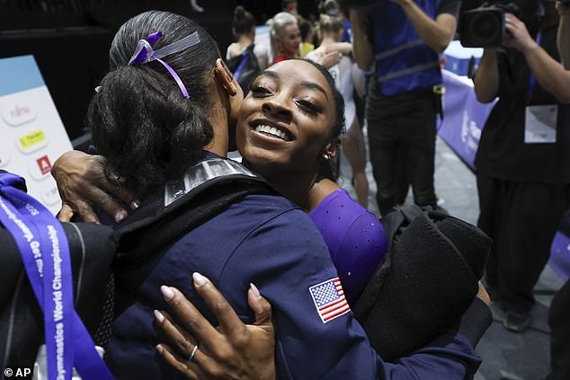 Biles is hugged by United States' Shilese Jones, left, after the floor exercise