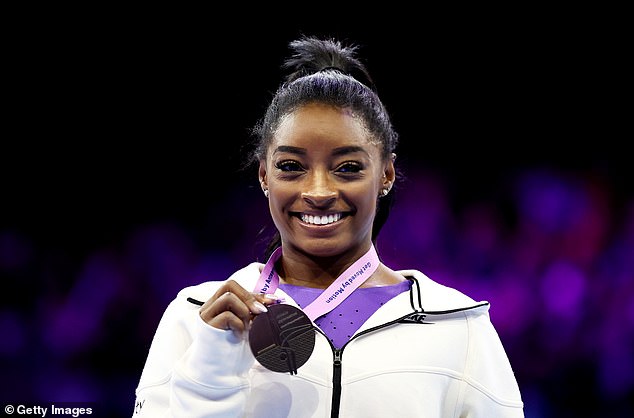 Simone Biles of Team United States celebrates gold on the Beam on Day Nine