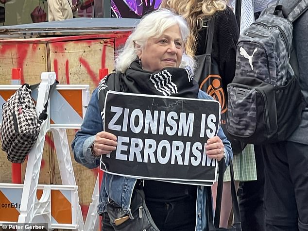 One woman holds up a sign: 'Zionism is terrorism'