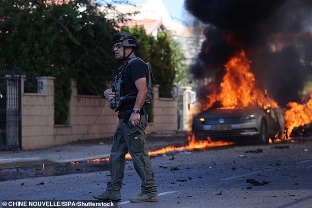 A member of Israeli police is seen yesterday in Ashkelon, southern Israel after the Hamas offensive