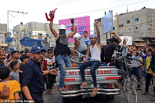 Palestinians are greeted by crowds after returning from crossing the border into Israel on Saturday