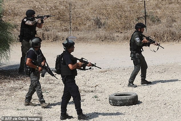 Israeli forces, sent to the border with Gaza in southern Israel, scan the area near Ashdod on October 8, 2023 as the battle against Hamas fighters continues.