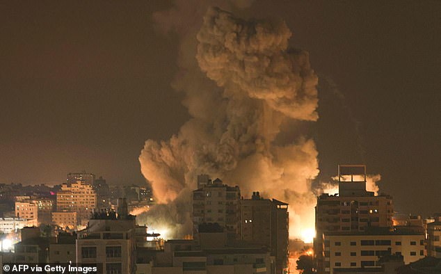 Fire and smoke rise above buildings in Gaza City during an Israeli airstrike on October 8, 2023. Israel, reeling from the deadliest attack on its territory in half a century, formally declared war on Hamas on Sunday as the Israeli death toll passed 700 rose.  the Palestinian militant group launched a massive surprise attack from Gaza