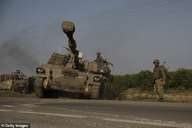 Israeli soldier directs armored vehicles on their way to the southern border with the Gaza Strip on October 8, 2023 in Sderot, Israel.  The nation is preparing a full-scale counteroffensive against the terrorist organization