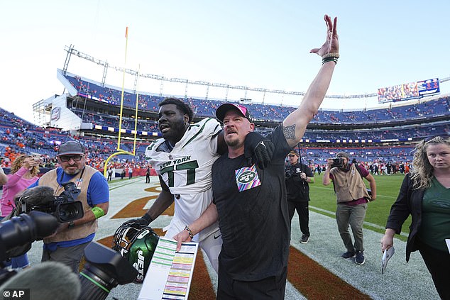 Jets offensive tackle Mehki Becton celebrates with Hackett as the two leave the field