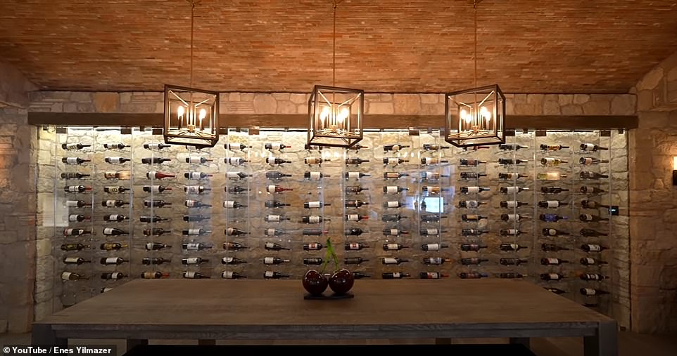 Enes says of the 'wine wall': 'I love how these bottles are displayed (on their side) it's obviously temperature controlled.  Then they brought the ceiling with barrels here too, which gives you that Tuscany feeling'