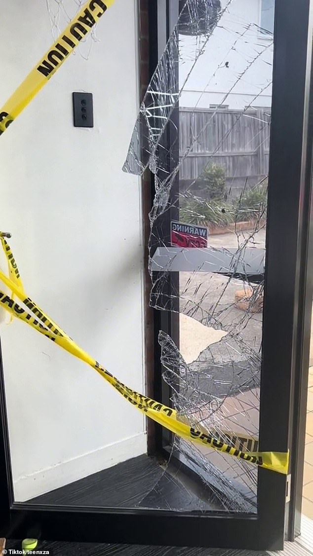 The devastated cafe owner said repairs would continue throughout the week.  In the photo is the front window and the broken door