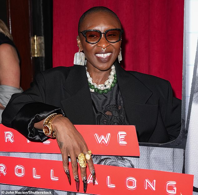 Finishing off the look: The performer contrasted the dark tone of her outfit with white and green necklaces, and accessorized with a pair of wide-framed sunglasses