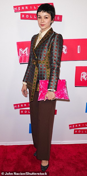 Stylish: Julia Chan opted for a patterned jacket that contrasted with a beige button-down shirt and brown trousers