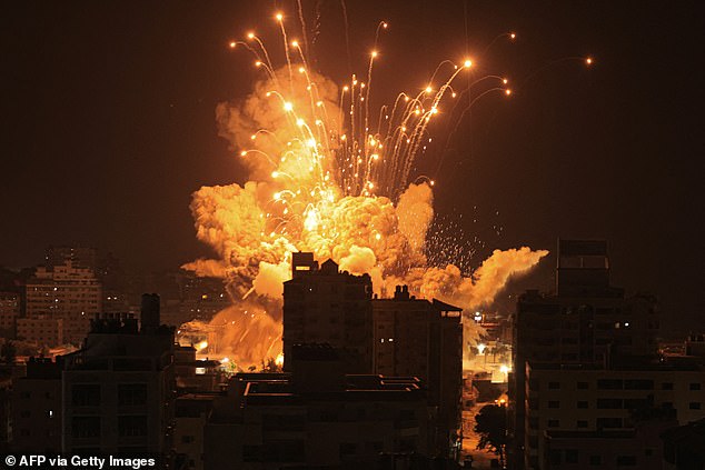 A missile explodes Sunday evening in Gaza City during an Israeli air strike