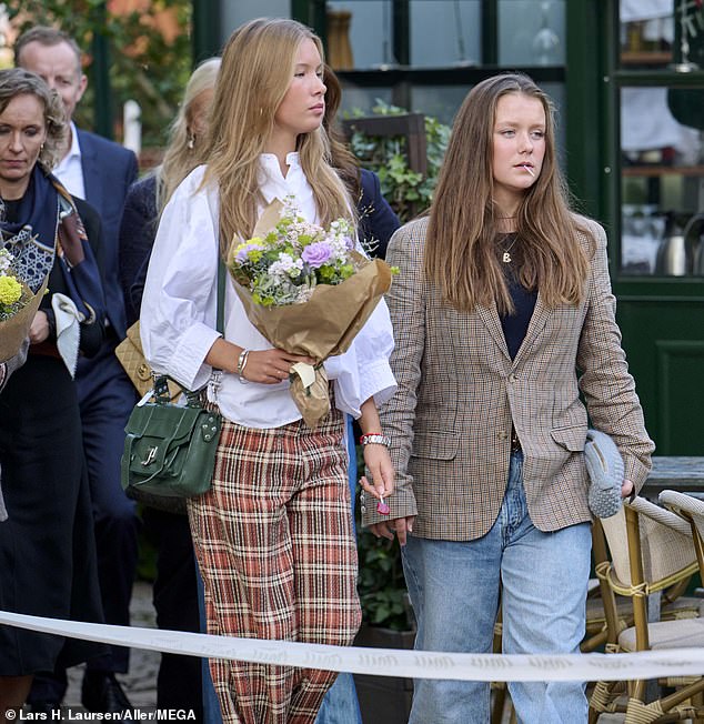 While Princess Isabella wore flared trousers like her mother and she teamed her ensemble with a plaid jacket