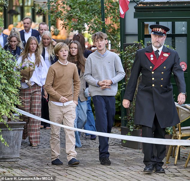 Elsewhere Prince Vincent looked autumnal in cream trousers and a brown wool top