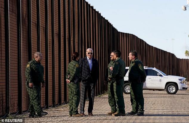 Joe Biden talks with Border Patrol agents as he walks along the border during his visit to El Paso, Texas in January 2023.