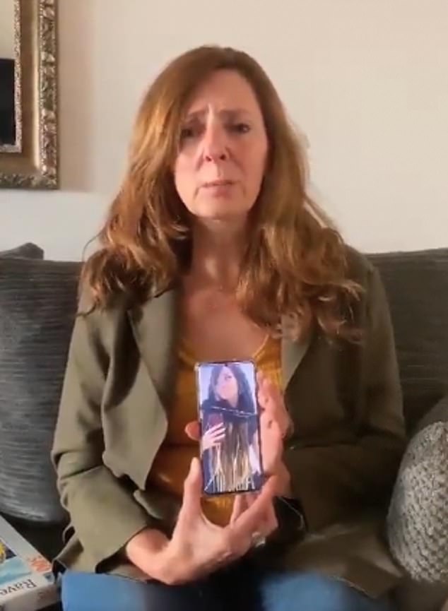 Shani's mother Ricarda holds up a picture of her daughter on her mobile phone in an emotional video appeal pleading for help to find out what happened to her daughter