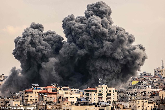 A plume of smoke rises into the sky of Gaza City during an Israeli airstrike on October 9