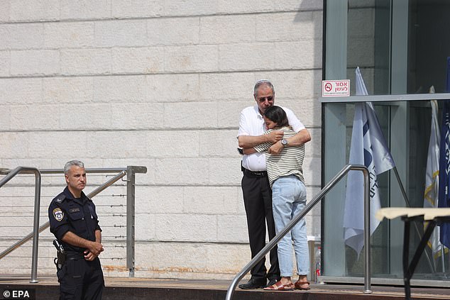 A woman was comforted by a police officer outside the centre