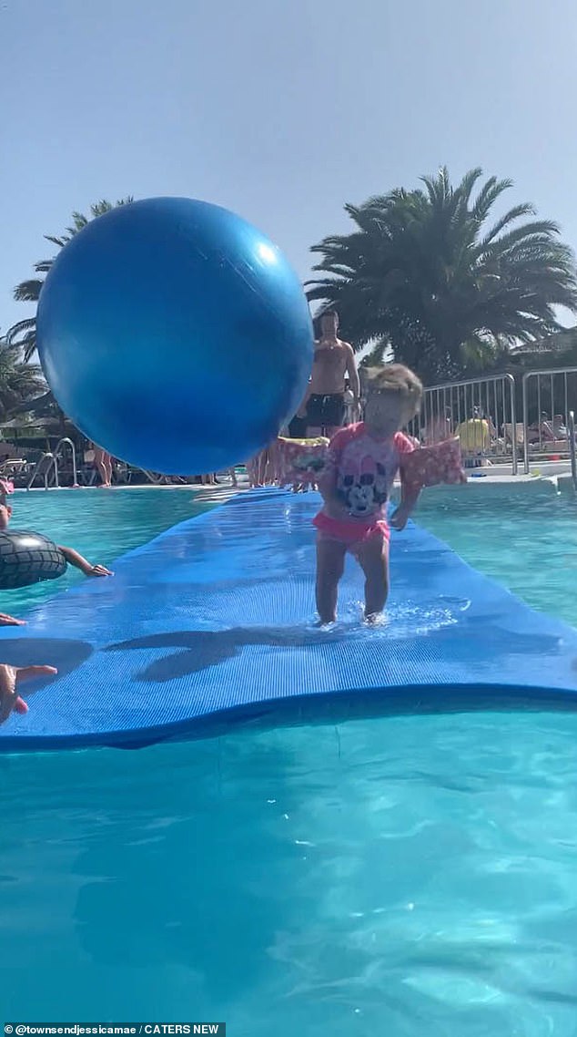 After taking the next fatal step, Alex was suddenly knocked off her feet by a giant bouncy beach ball.