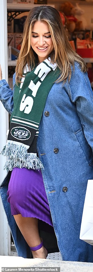 Showing her support!  She also wore a New York Jets scarf - the football team her husband used to play for