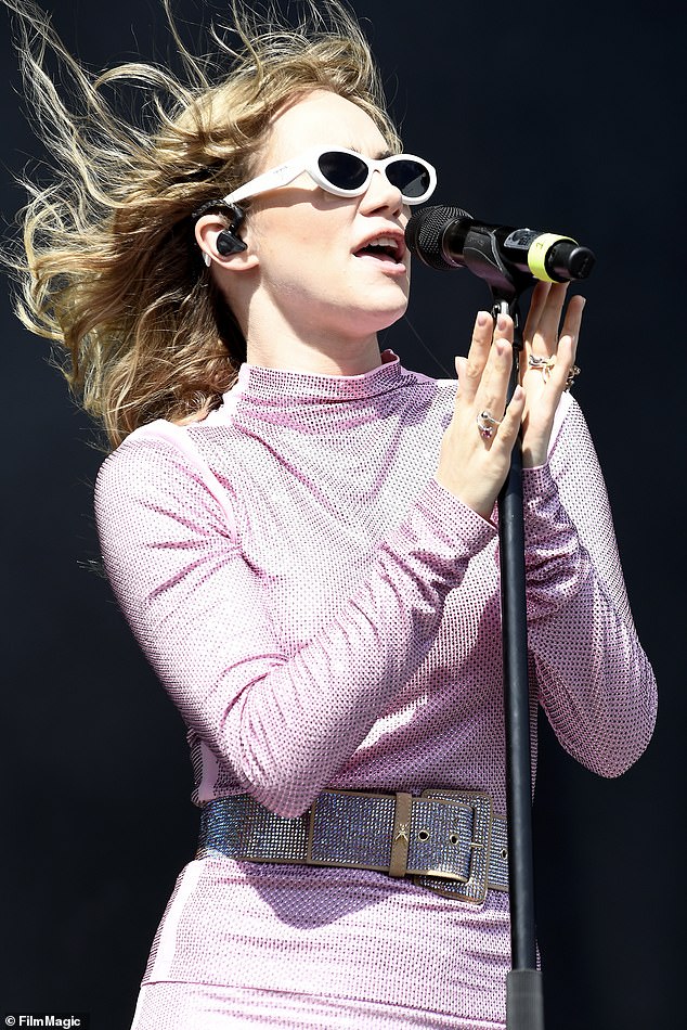 In style: Keeping out of the sun, she donned a pair of baby pink sunglasses framed by cat eyes