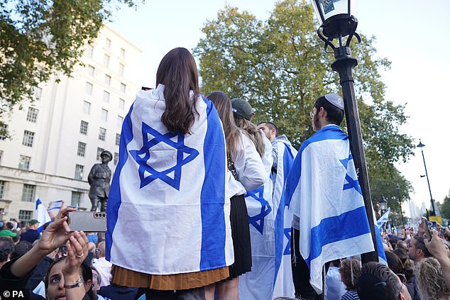 Contrary to most Western reports, the terrorists' cynical massacre of defenseless civilians, rape of women and kidnapping of others, receive little mention in the Arab media.  Pictured against protesters at a Palestinian Solidarity Campaign demonstration near the Israeli embassy in Kensington