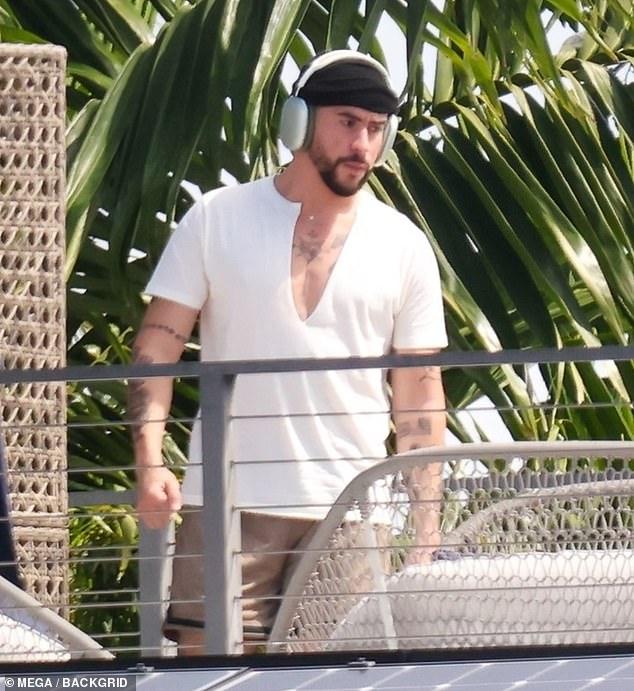 Outfit: The Puerto Rico native wore a short-sleeved shirt with a plunging V-neckline that flashed his toned chest