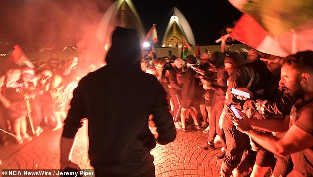 Pictured: Chaotic scenes at the Sydney Opera House, as a protest featured pro-Palestinian protesters - some wearing black masks - chanting 'f*** Israel' and 'f*** the Jews'