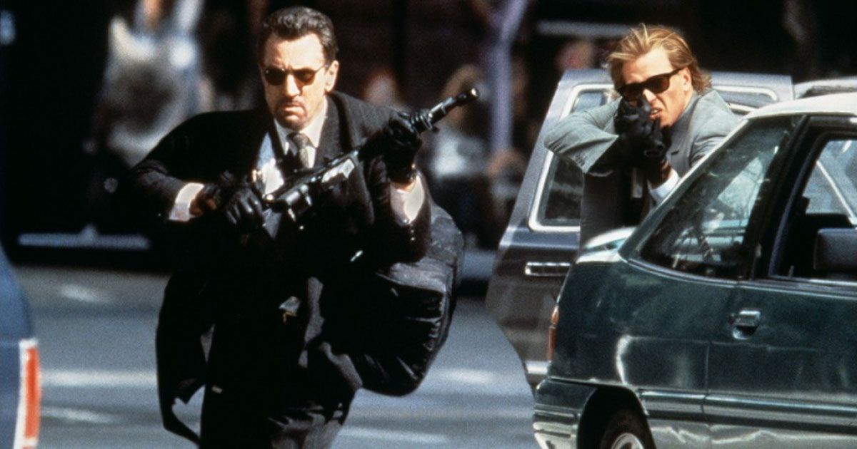 professional bank robbers Neil McCauley (Robert De Niro) and Chris Shiherlis (Val Kilmer) touts guns in a warm-up with the police.