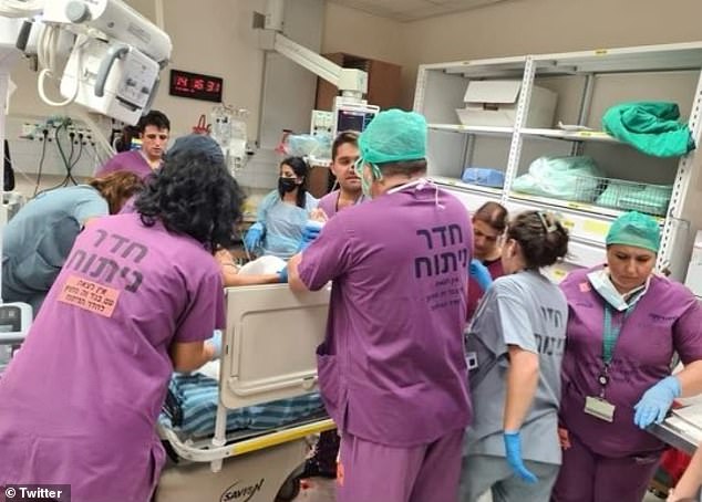 Frontline workers tend to a patient (pictured) while providing care to victims of the Hamas attack.  Soroka CEO Shlomi Codish said they treated a pregnant woman who was shot in the stomach.  The woman survived, the baby did not