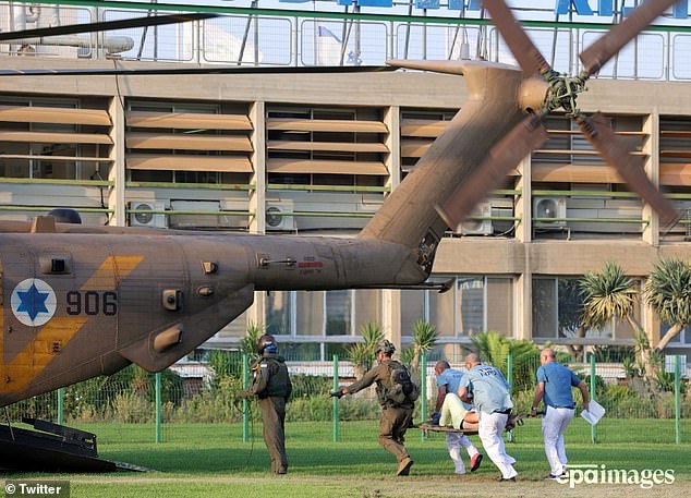 Israeli soldiers and medical personnel transfer a victim to a hospital in Jerusalem.  The hospital used helicopters to transport the first wave of 700 patients to make room for others