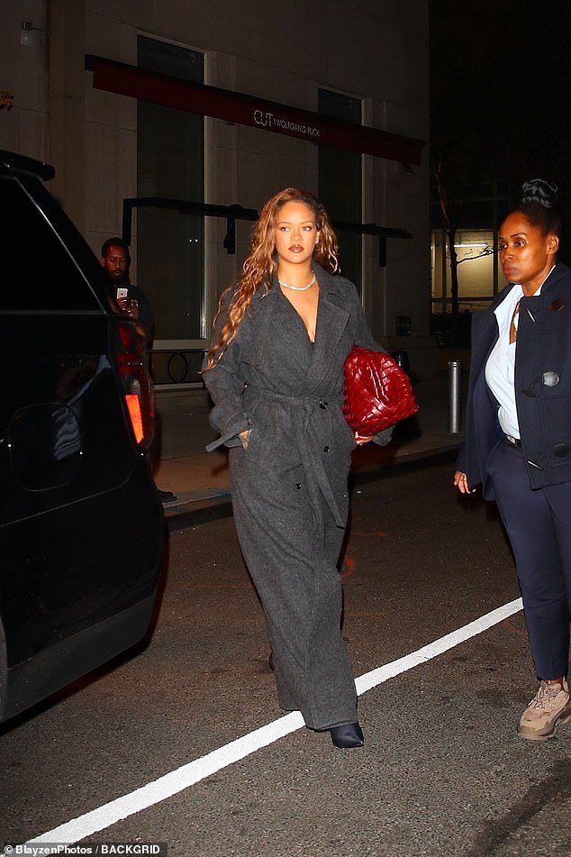 Fashion icon: All eyes were on the Diamonds hitmaker, 35, after she grabbed a bite to eat as she walked to her car in a dark gray Dries Van Noten coat and a pair of towering Balenciaga pumps