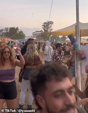 In footage posted to TikTok, revelers appeared oblivious to the looming terror hovering hundreds of feet above their heads in the distance.