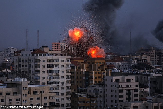 Israel has now responded by launching deadly retaliatory airstrikes on Gaza after the defense minister called for a 'full siege' of the coastal enclave.  In the photo, smoke can be seen rising and fireball over a building in Gaza City on Monday during an Israeli airstrike