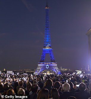 The Eiffel Tower is illuminated in the colors of the Israeli flag and the Star of David