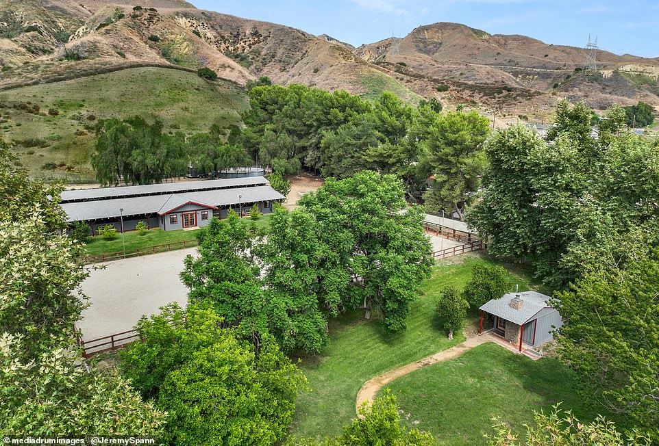 The beautiful farm is located on the outskirts of Los Angeles within the rolling hills of Southern California's San Fernando Valley and even has a guest house (right) in addition to the main homestead (left)