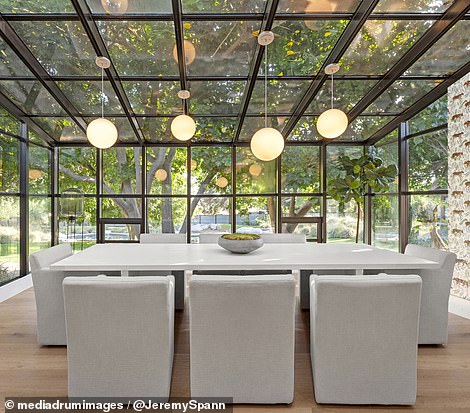 The home has a glazed atrium that overlooks expansive pastures and mature trees