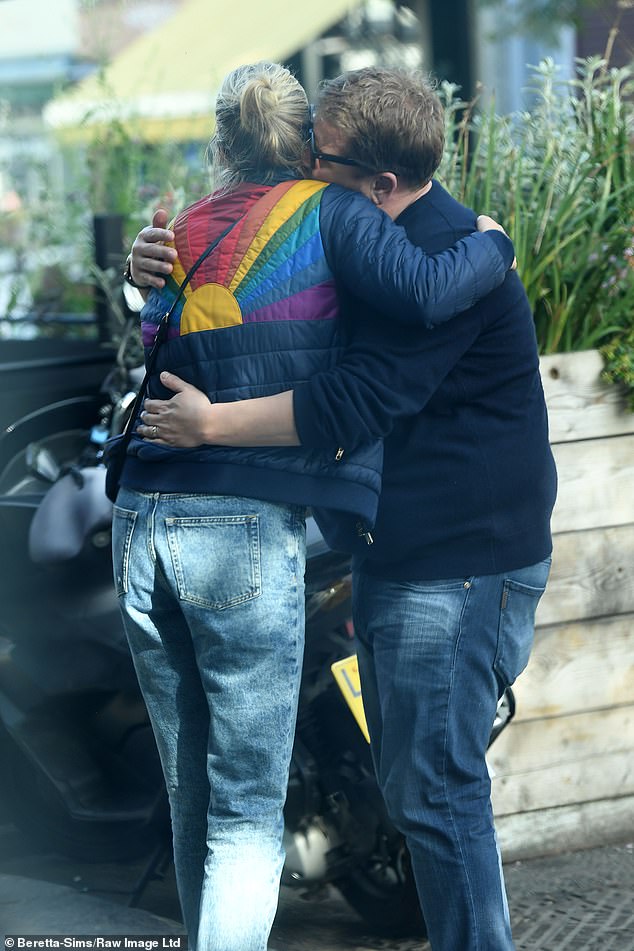 Well put together: James was dressed casually for the date, wearing a navy jumper and jeans Julia teamed jeans and trainers with a padded jacket which had a rainbow motif on the back