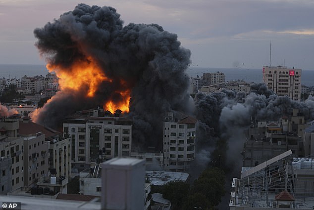 Fire and smoke rise from an explosion on a Palestinian apartment tower following an Israeli airstrike in Gaza City just hours after the festival attack as the Israeli counter-offensive began