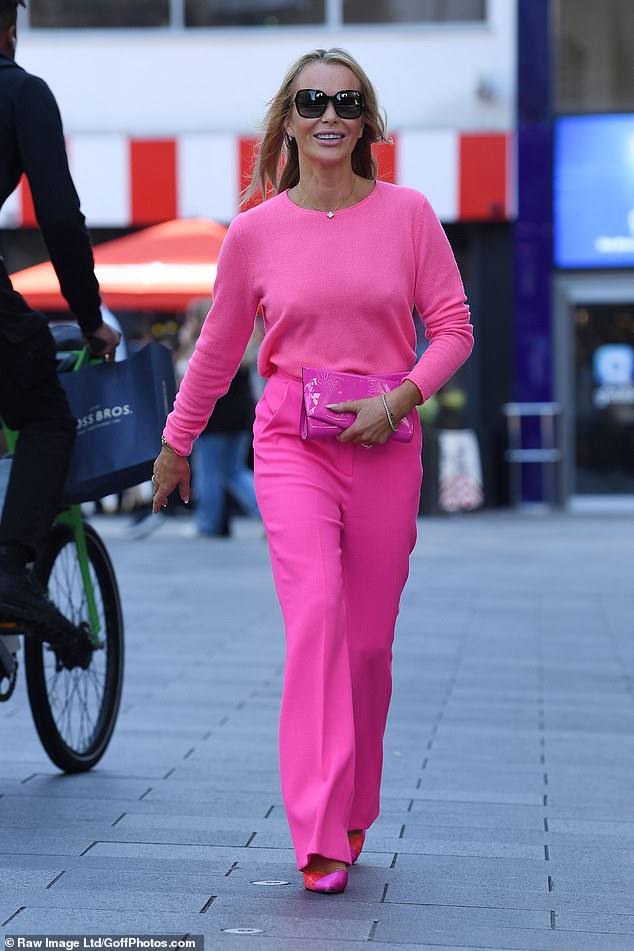 Stunning: Amanda, 52, was equally stunning in her bold pink style, channeling Barbie in the look