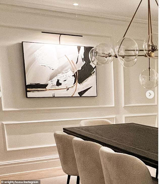 Neutral: The dining room has paneled walls painted off-white and decorated with modern art