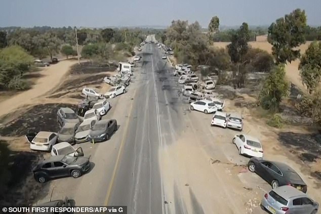 Several cars - some of them burnt out - are pulled over on the side of the road after people fled the Nova music festival in southern Israel.