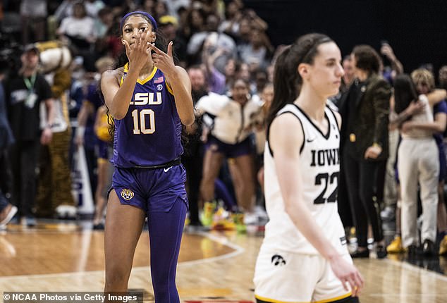 LSU's Angel Reese gestures to her ring finger as Iowa's Caitlin Clark walks by