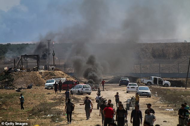 Smoke is seen on October 7 near the border fence between Gaza and Israel