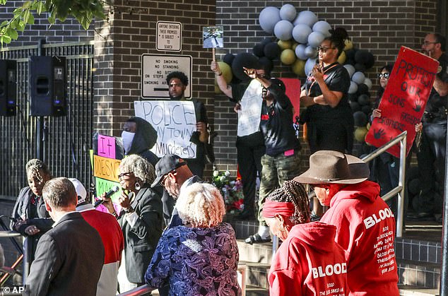 Hundreds of people gathered outside Decatur City Hall Thursday night in a vigil for Perkins