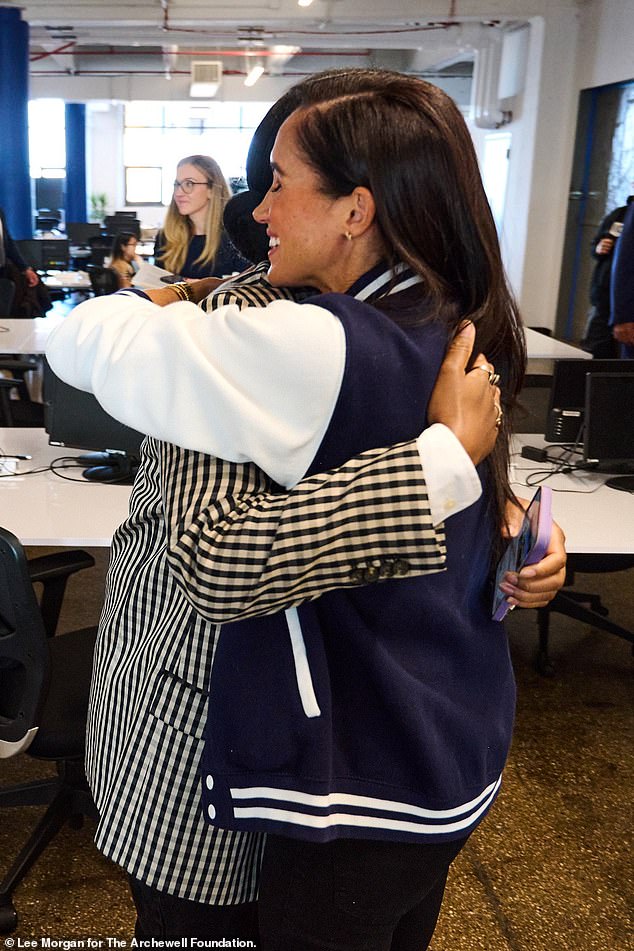 Images shared by Harry and Meghan's friend and member of the media Omid Scobie show the duo posing with several students at the school.  The Duchess is pictured sneaking in a hug