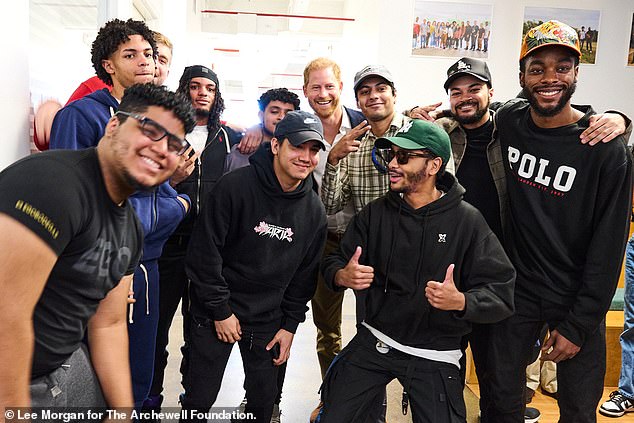 Scobie added that Harry and Meghan joined a 'mindful meditation session' during which the students opened up about how they were feeling.  In the photo Harry is with some students