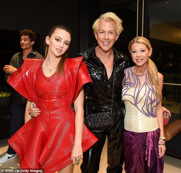 L-R: Natasha Bassett, Derek Warburton and Tara get ready for a photo