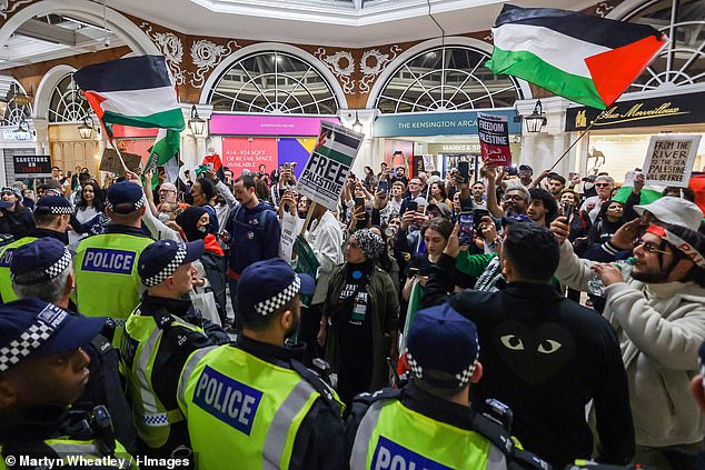 Police had to separate protesters carrying Palestinian and Israeli flags at High Street Kensington tube station on Monday.