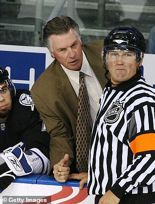 Head coach Barry Melrose of the Tampa Bay Lightning discusses a call with referee Don Koharski #12 during action against the Pittsburgh Penguins in a preseason game at the St. Pete Times Forum on September 22 2008.